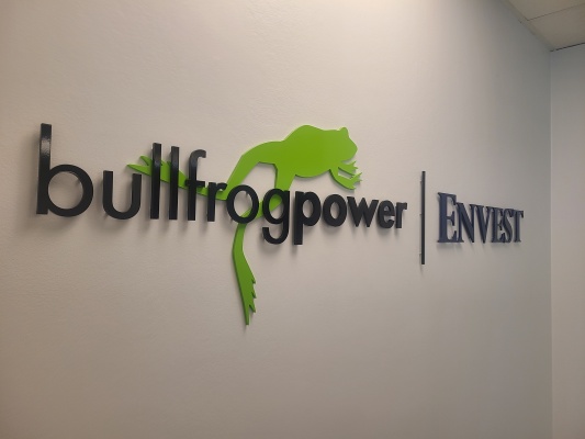 Custom 2 layered 3D cut acrylic logo installed raised from the wall "bullfrog power"