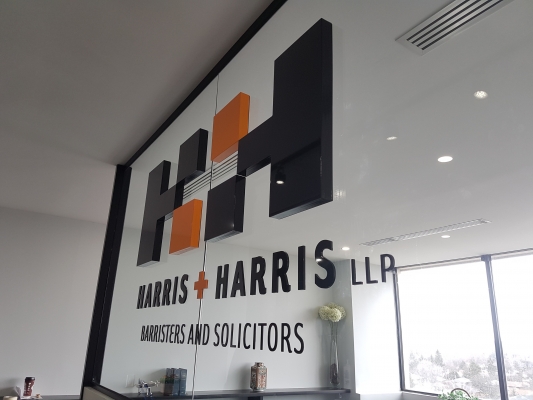 Raised 3D cut letters installed flush to the glass wall H