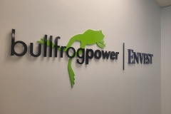 Custom 2 layered 3D cut acrylic logo installed raised from the wall "bullfrog power"