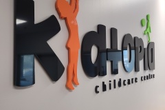 Custom-3D-cut-acrylic-letters-painted-to-match-the-Pantone-colors-installed-raised-from-the-wall-for-Kidtopia-Child-Care-Centre