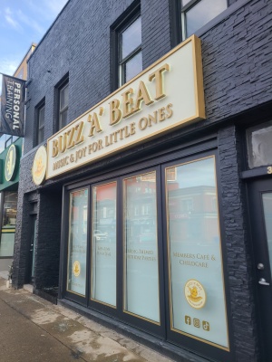 Custom aluminum sign box with fabricated metal letters LED illuminated from behind Buzz 'A' Beat