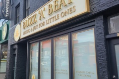 Custom aluminum sign box with fabricated metal letters LED illuminated from behind Buzz 'A' Beat