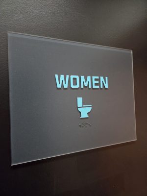 Women Washroom Sign  with raised graphics and braille. 
