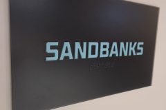 Custom clear acrylic office sign with raised graphics and braille.