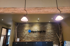 Custom-clear-acrylic-reception-sign-with-3D-cut-logo