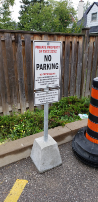 Custom parking sign with concrete base and post
