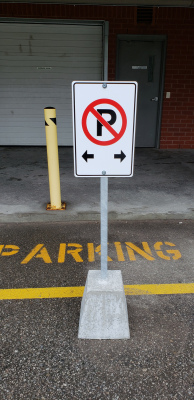 No-parking-signs-with-post-on-concrete-base