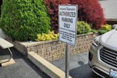 Custom-aluminum-parking-sign-on-a-post-with-concrete-base