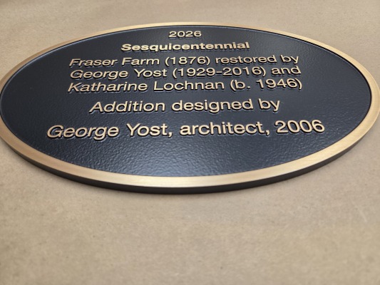 Oval shaped custom bronze plaque with raised graphics