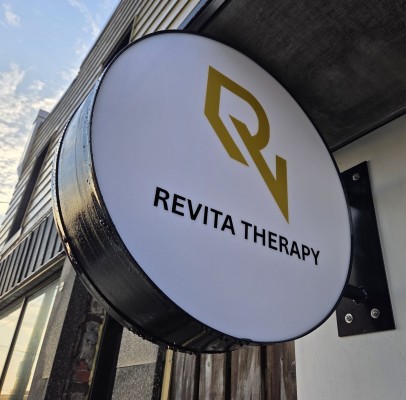 Custom LED illuminated circular sign box "Revita Therapy"