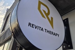 Custom LED illuminated circular sign box "Revita Therapy"
