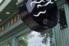 Double-sided-circular-sign-box-with-3D-raised-graphics